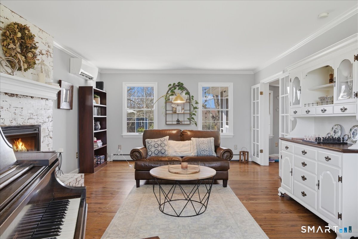 792 Wrights Crossing Road Pomfret, CT 06259 - Photo 11 of 40 a living room with furniture and a fireplace