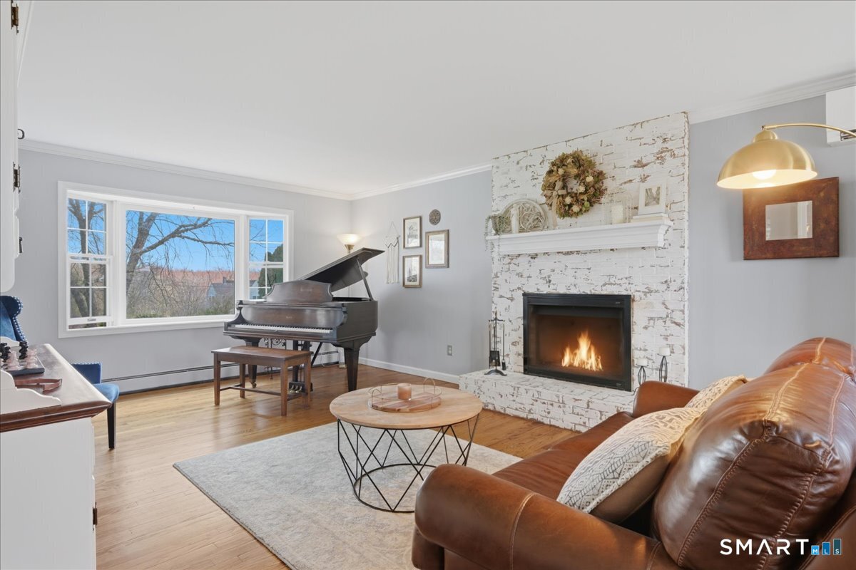 792 Wrights Crossing Road Pomfret, CT 06259 - Photo 12 of 40 a living room with furniture a rug and a fireplace