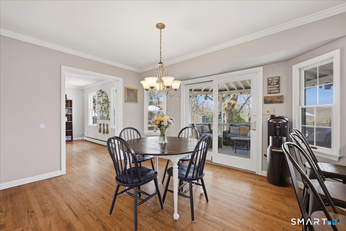 792 Wrights Crossing Road Pomfret, CT 06259 - Photo 15 of 40 a view of a dining room with furniture window and wooden floor