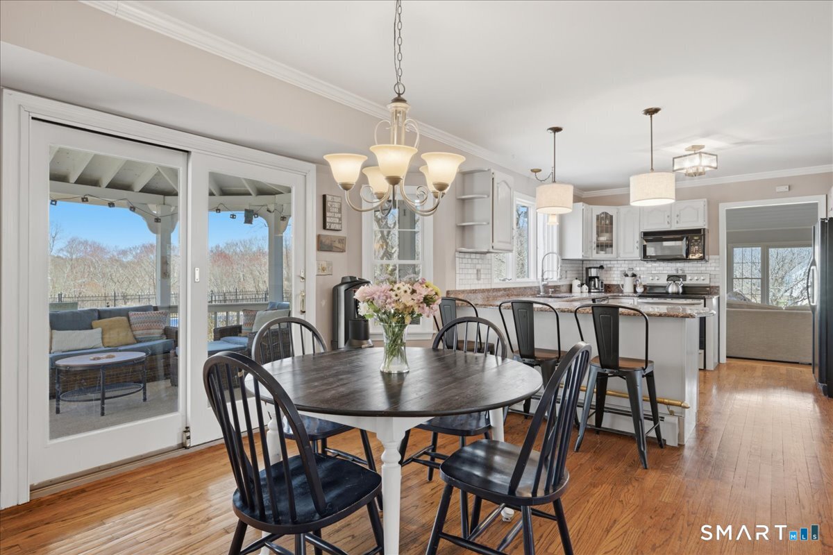 792 Wrights Crossing Road Pomfret, CT 06259 - Photo 16 of 40 a dining room with furniture a chandelier and wooden floor