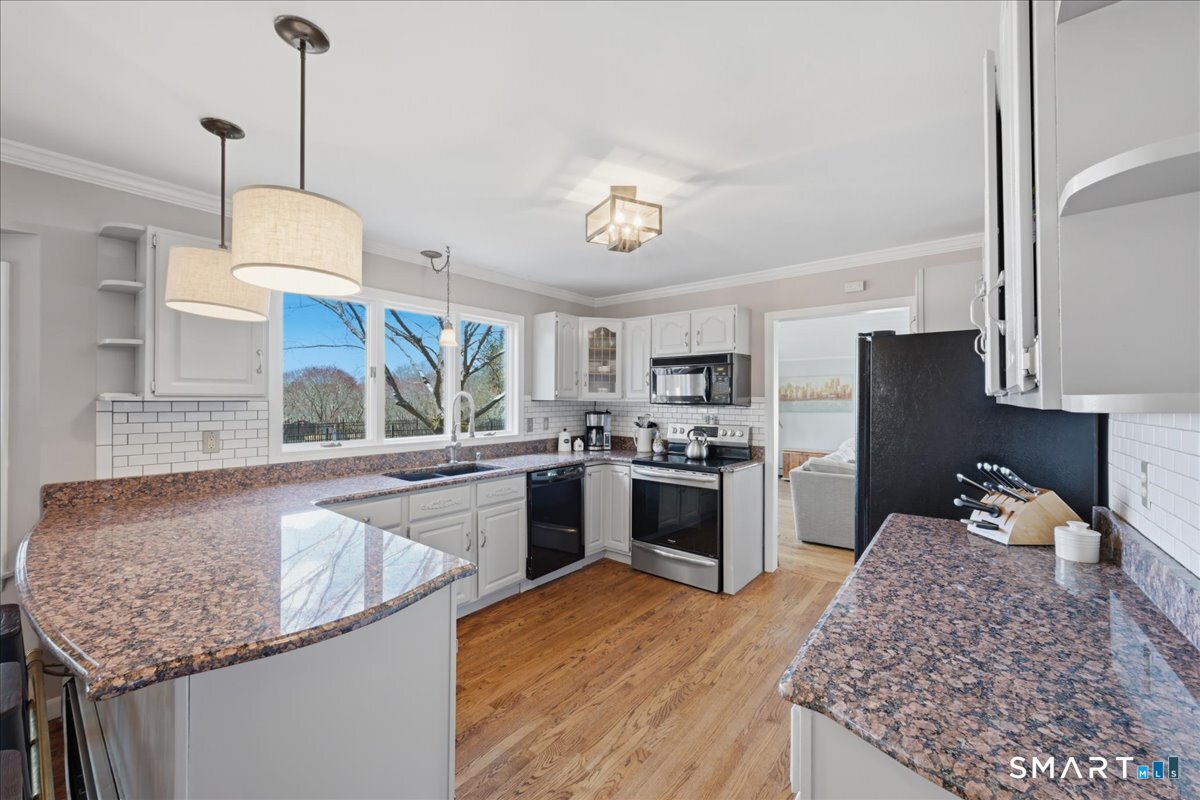 792 Wrights Crossing Road Pomfret, CT 06259 - Photo 17 of 40 a kitchen with stainless steel appliances granite countertop a sink dishwasher stove and refrigerator with wooden floor