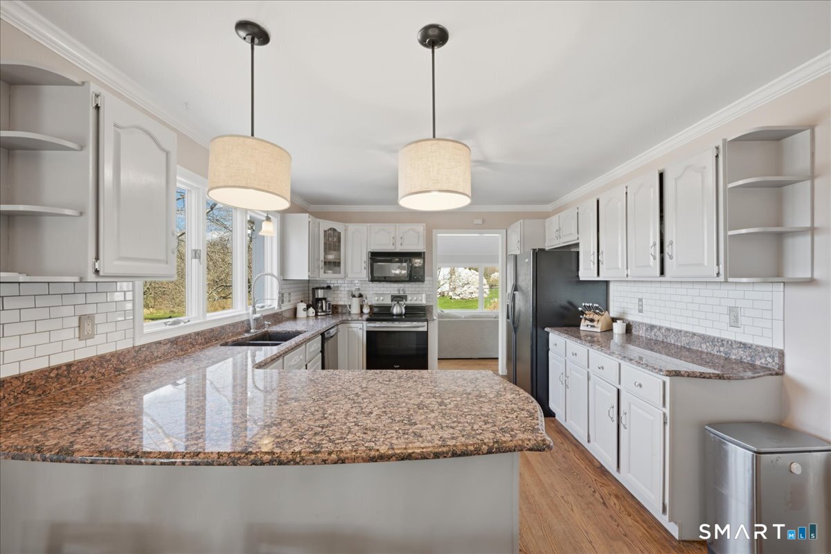 792 Wrights Crossing Road Pomfret, CT 06259 - Photo 18 of 40 a kitchen with stainless steel appliances granite countertop a sink a stove top oven a counter space and cabinets
