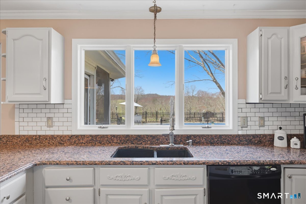 792 Wrights Crossing Road Pomfret, CT 06259 - Photo 19 of 40 a kitchen with granite countertop a sink and a window