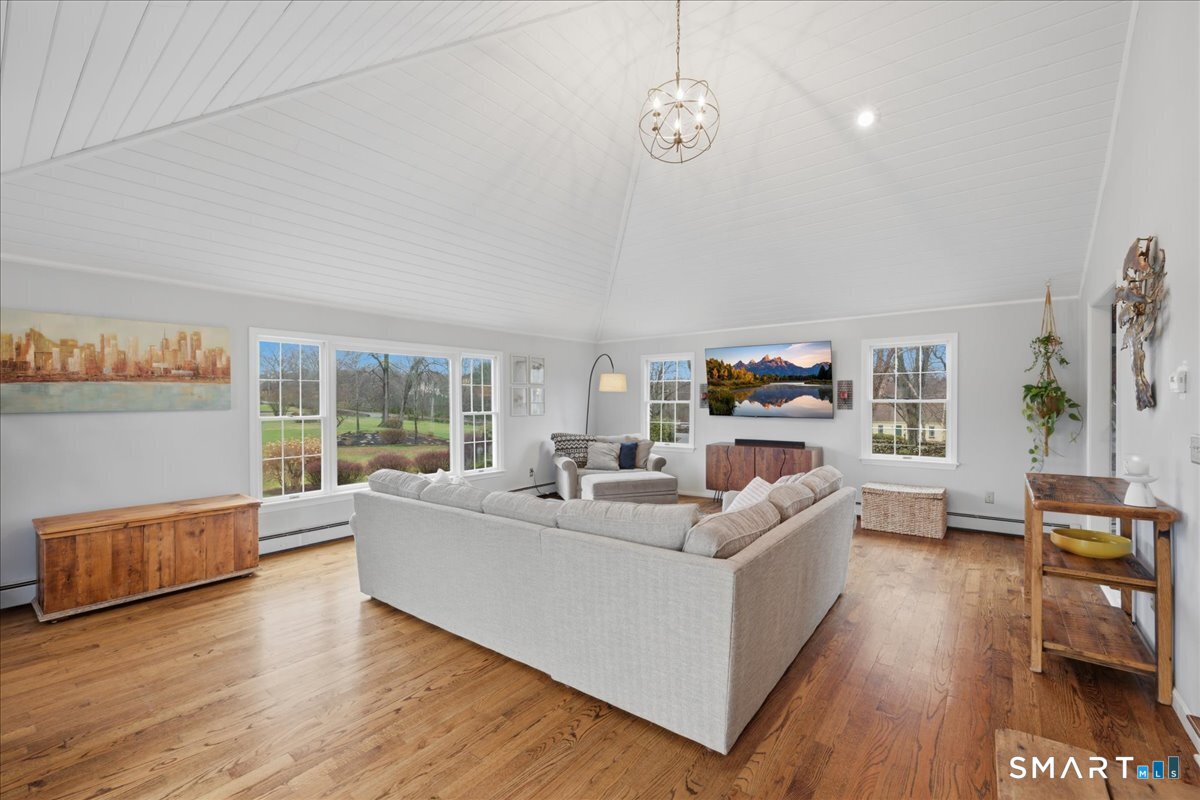792 Wrights Crossing Road Pomfret, CT 06259 - Photo 24 of 40 a living room with furniture and a wooden floor
