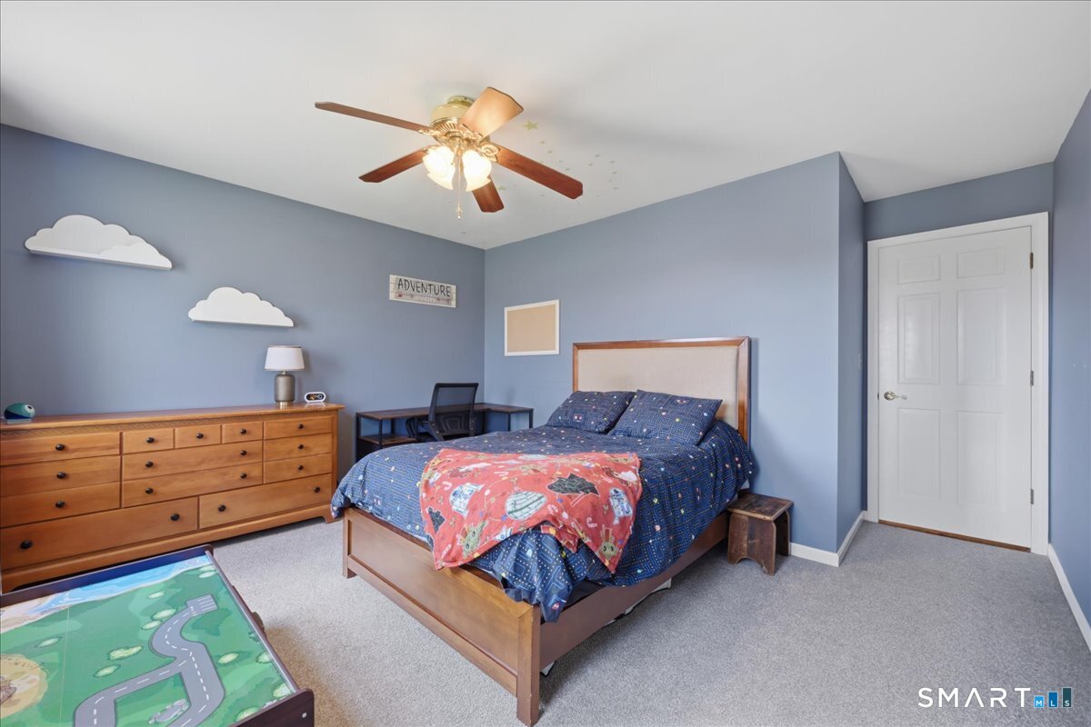 792 Wrights Crossing Road Pomfret, CT 06259 - Photo 32 of 40 a bed room with a bed and a chandelier