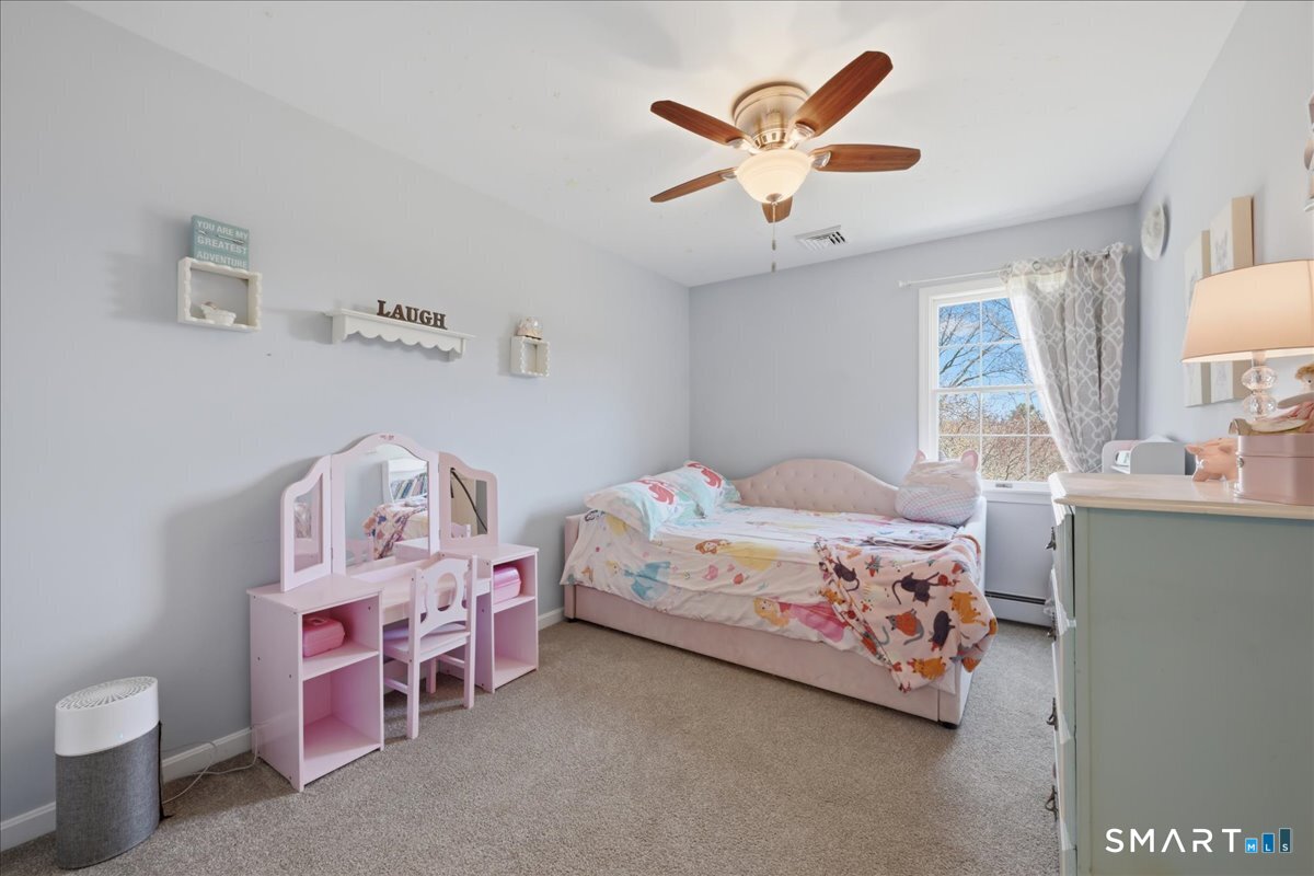 792 Wrights Crossing Road Pomfret, CT 06259 - Photo 33 of 40 a bedroom with a bed and a chandelier