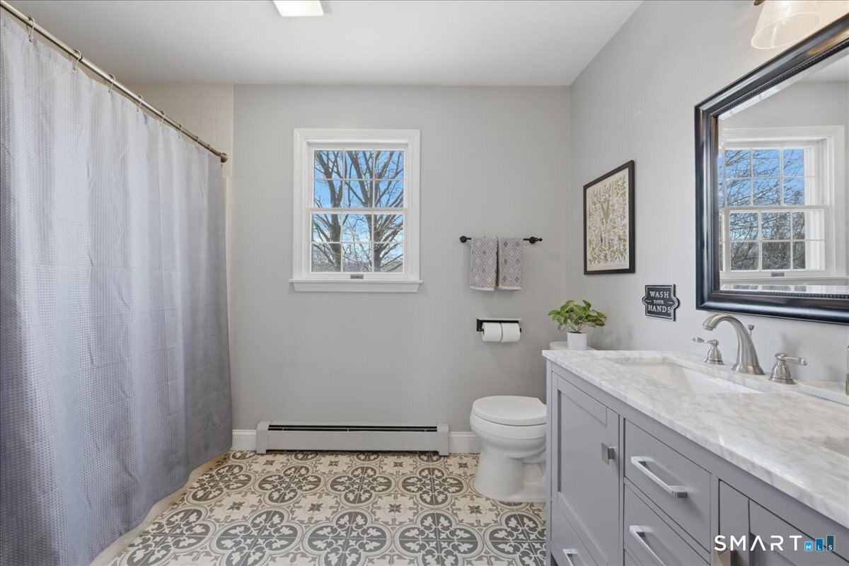 792 Wrights Crossing Road Pomfret, CT 06259 - Photo 34 of 40 a bathroom with a granite countertop sink toilet and mirror