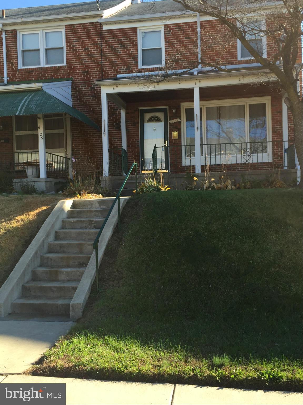 6127 Marlora Road Baltimore, MD 21239 - Photo 1 of 27 a front view of a house with garden