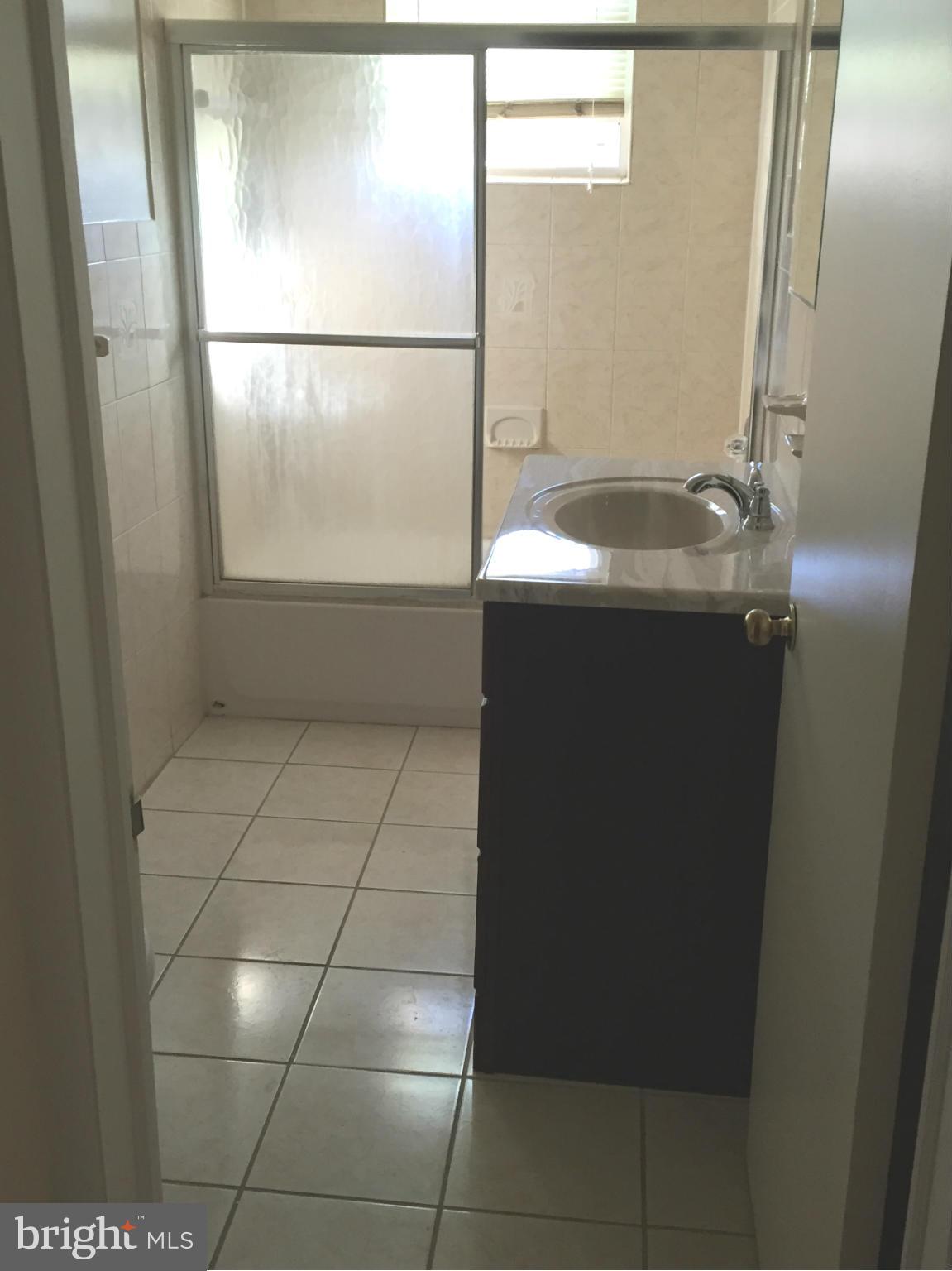 6127 Marlora Road Baltimore, MD 21239 - Photo 17 of 27 a bathroom with a sink and a mirror