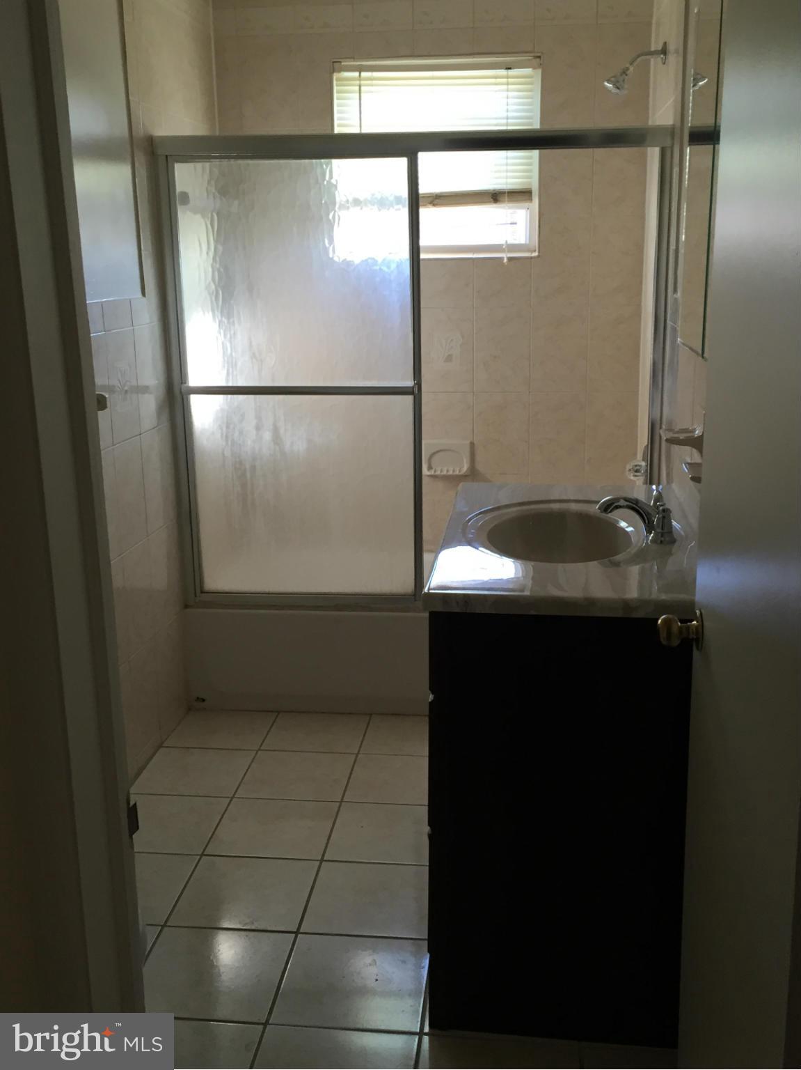 6127 Marlora Road Baltimore, MD 21239 - Photo 18 of 27 a bathroom with a sink and a mirror