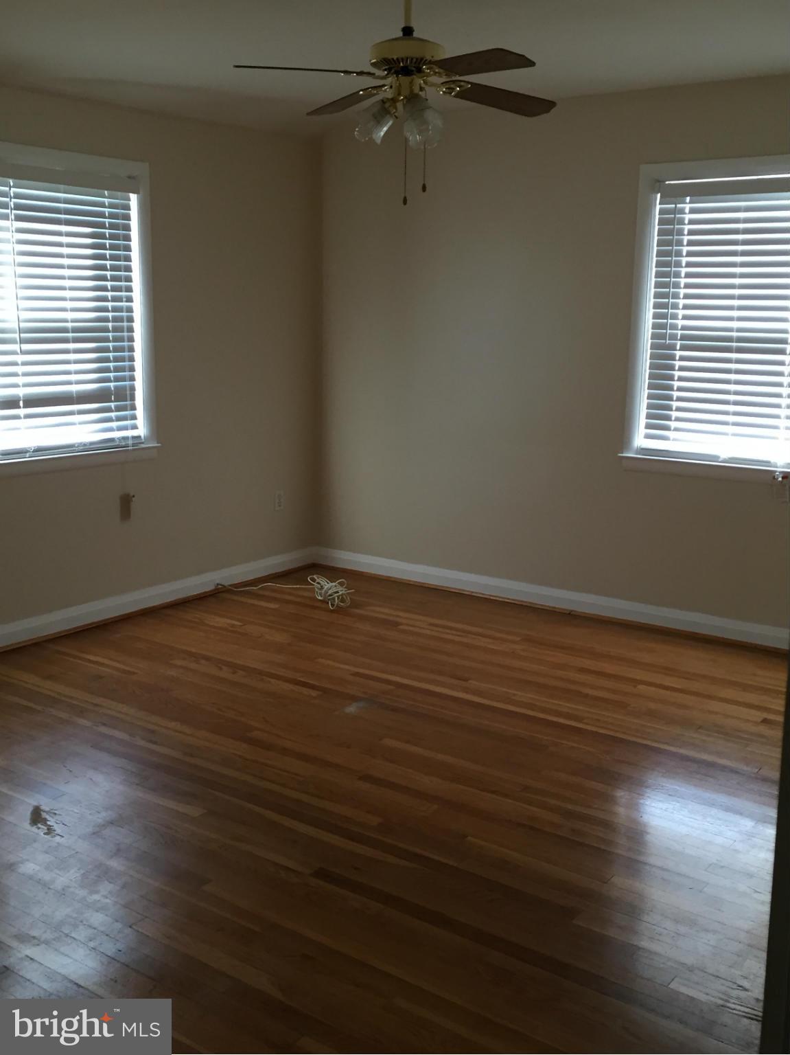 6127 Marlora Road Baltimore, MD 21239 - Photo 19 of 27 an empty room with wooden floor and windows