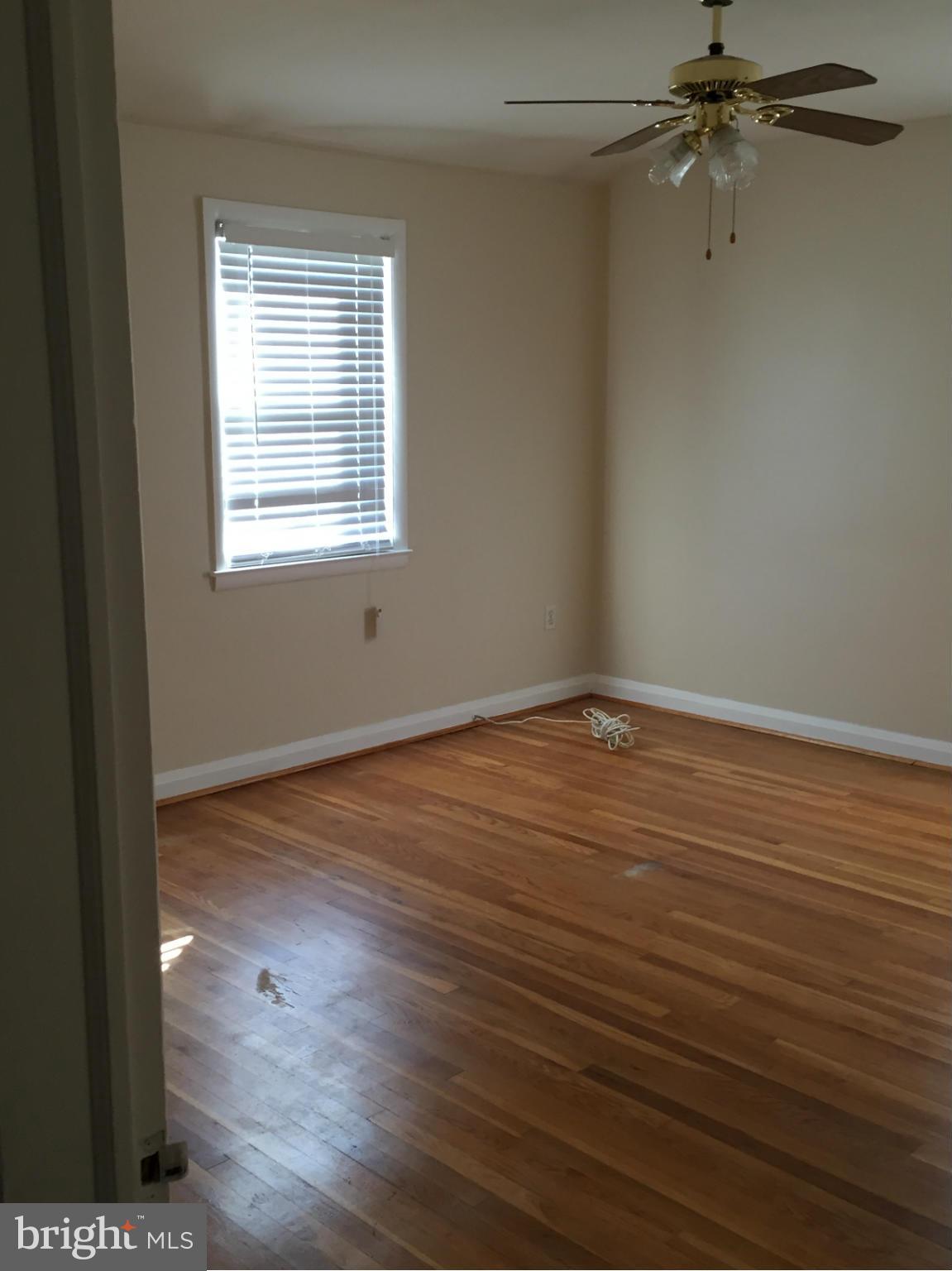 6127 Marlora Road Baltimore, MD 21239 - Photo 20 of 27 wooden floor in an empty room with a window