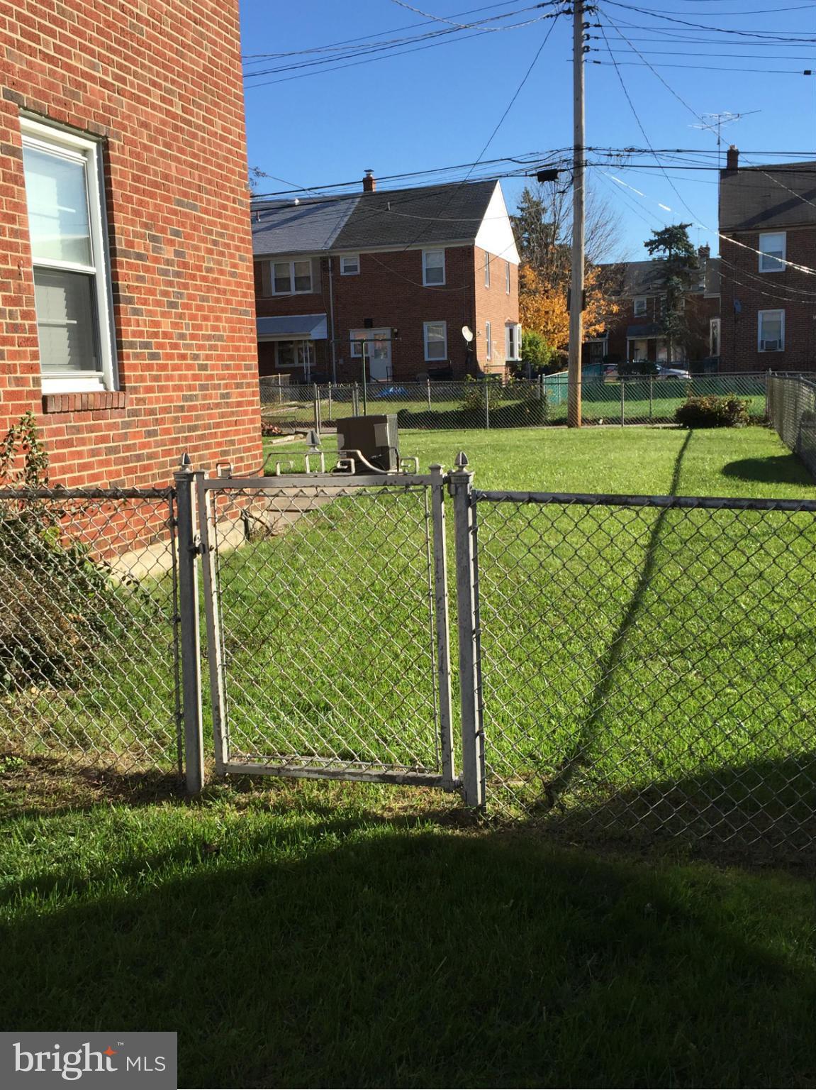 6127 Marlora Road Baltimore, MD 21239 - Photo 3 of 27 a front view of a house with a yard