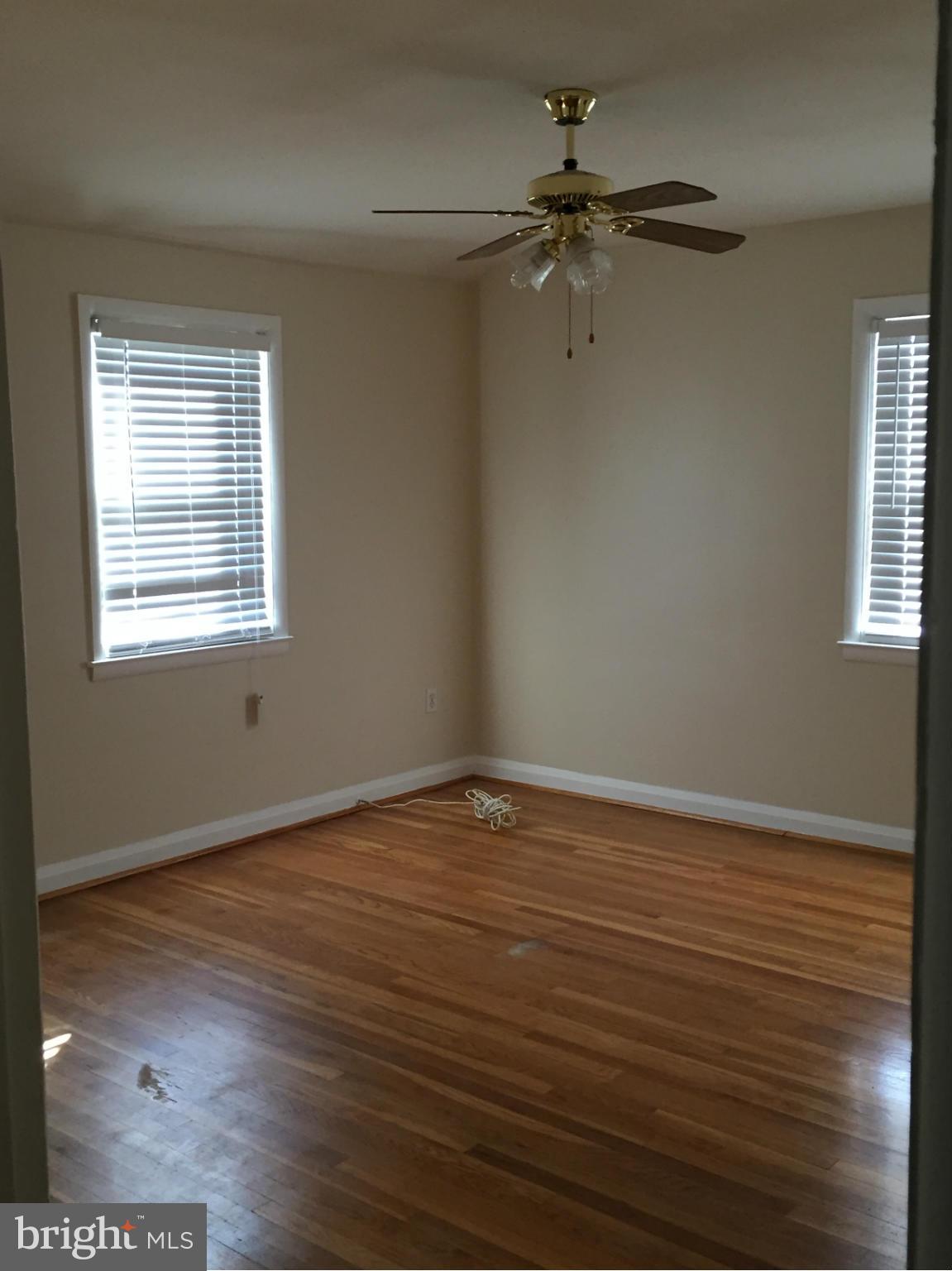 6127 Marlora Road Baltimore, MD 21239 - Photo 21 of 27 a view of an empty room with wooden floor and a window
