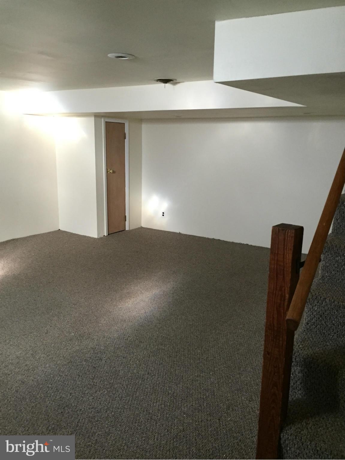 6127 Marlora Road Baltimore, MD 21239 - Photo 23 of 27 a view of an empty room with wooden floor