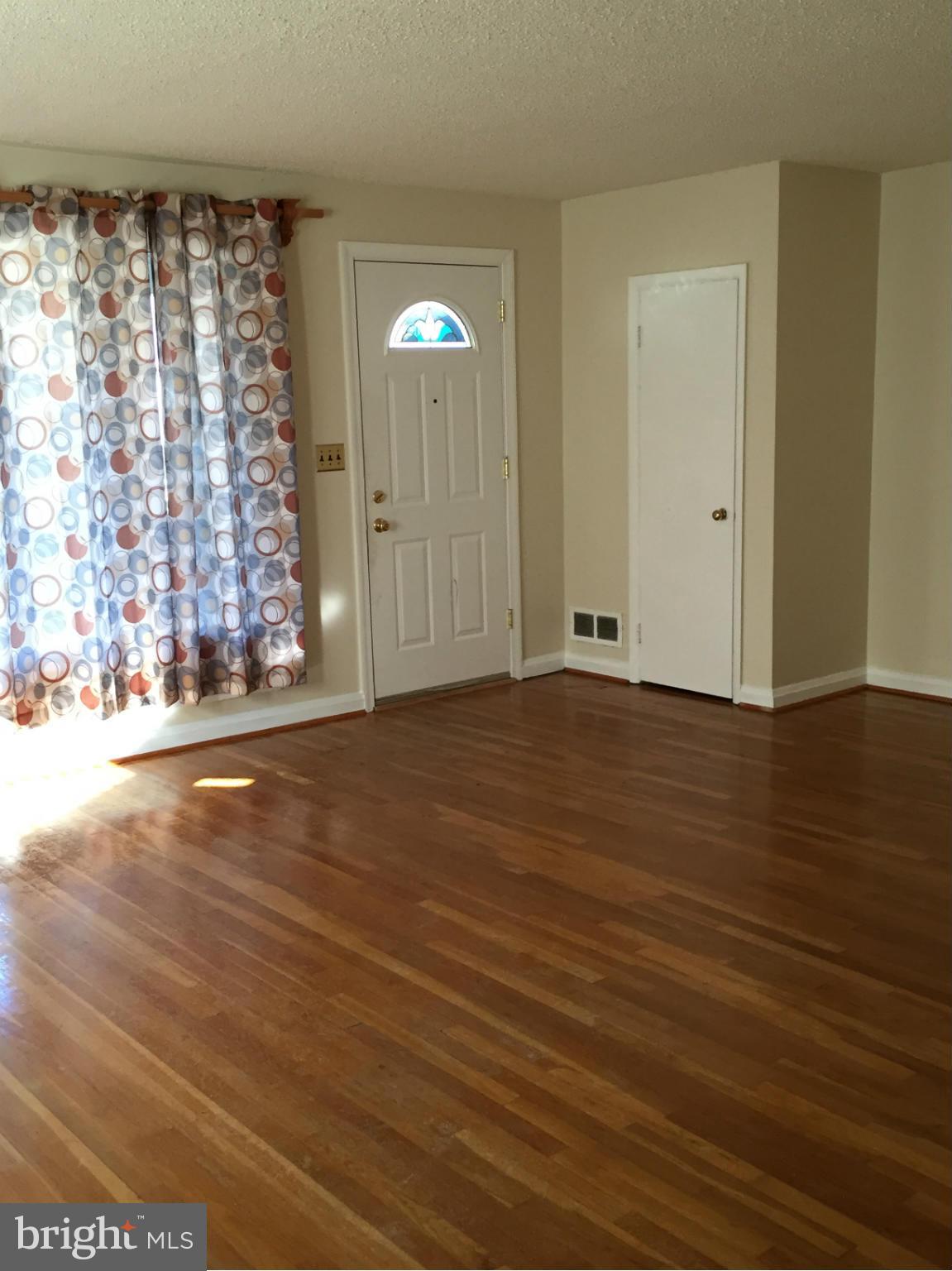 6127 Marlora Road Baltimore, MD 21239 - Photo 4 of 27 wooden floor in an empty room