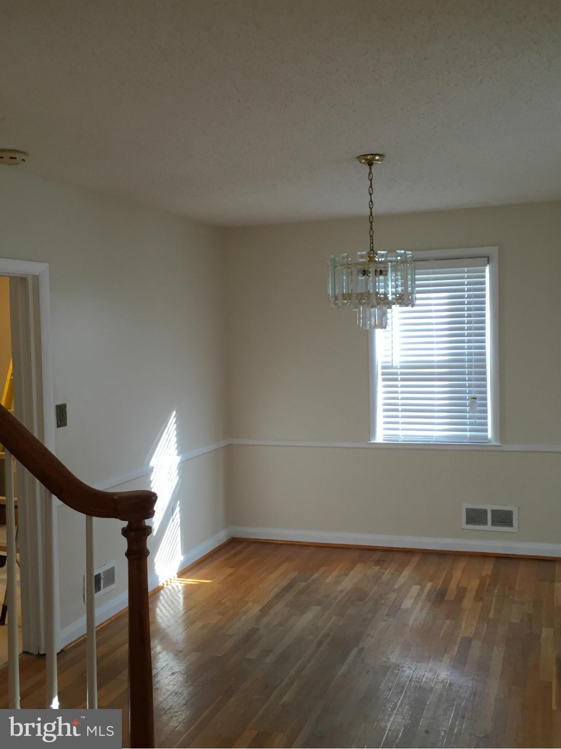 6127 Marlora Road Baltimore, MD 21239 - Photo 6 of 27 a view of empty room with wooden floor and fan