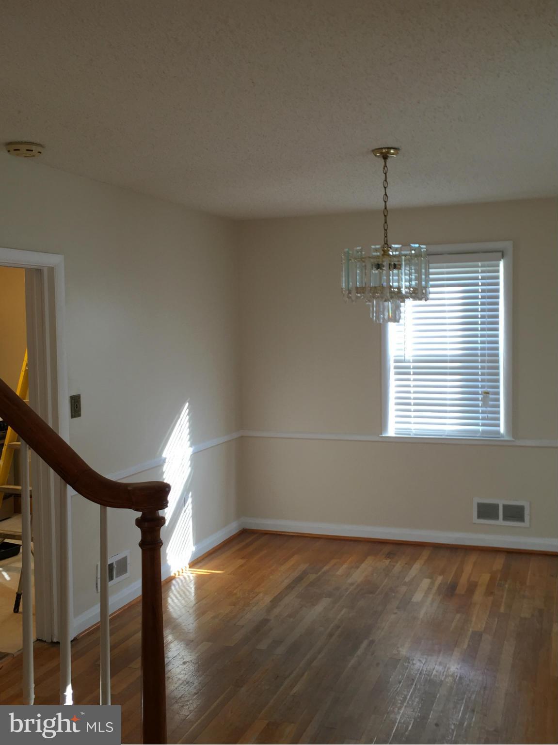 6127 Marlora Road Baltimore, MD 21239 - Photo 7 of 27 a view of empty room with wooden floor and fan