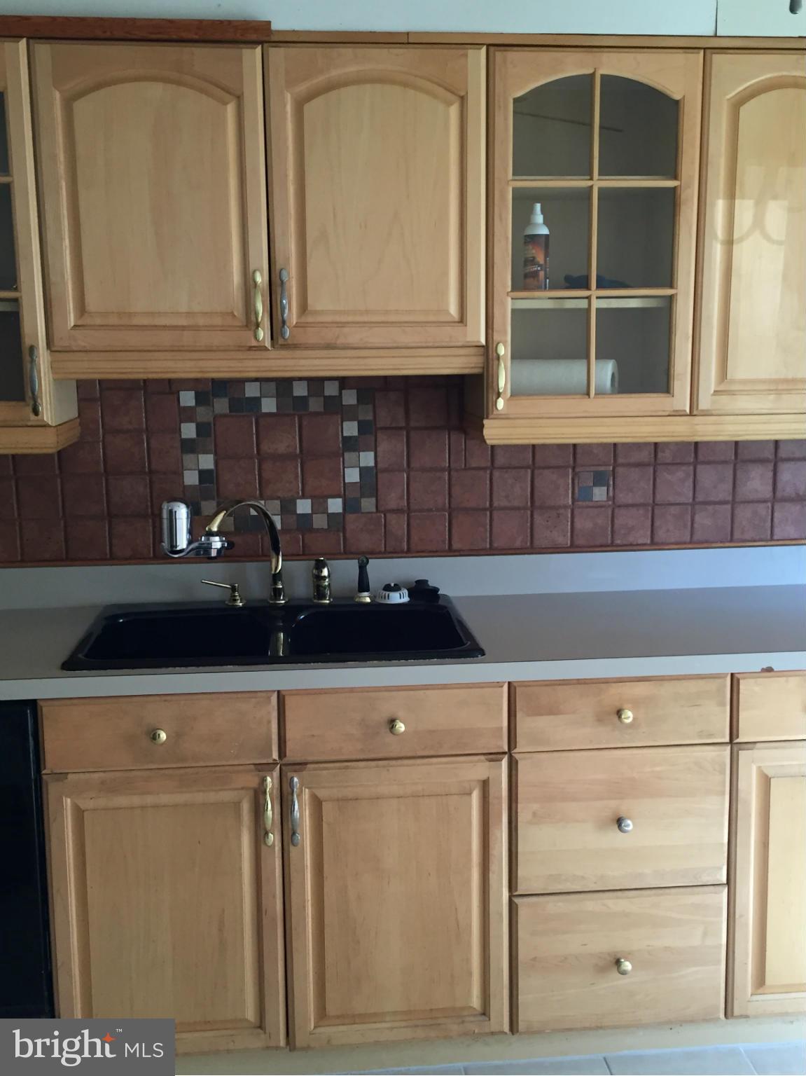 6127 Marlora Road Baltimore, MD 21239 - Photo 8 of 27 a kitchen with granite countertop white cabinets and sink