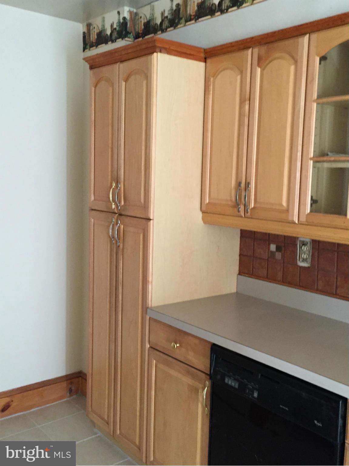 6127 Marlora Road Baltimore, MD 21239 - Photo 9 of 27 a kitchen with a refrigerator and cabinets