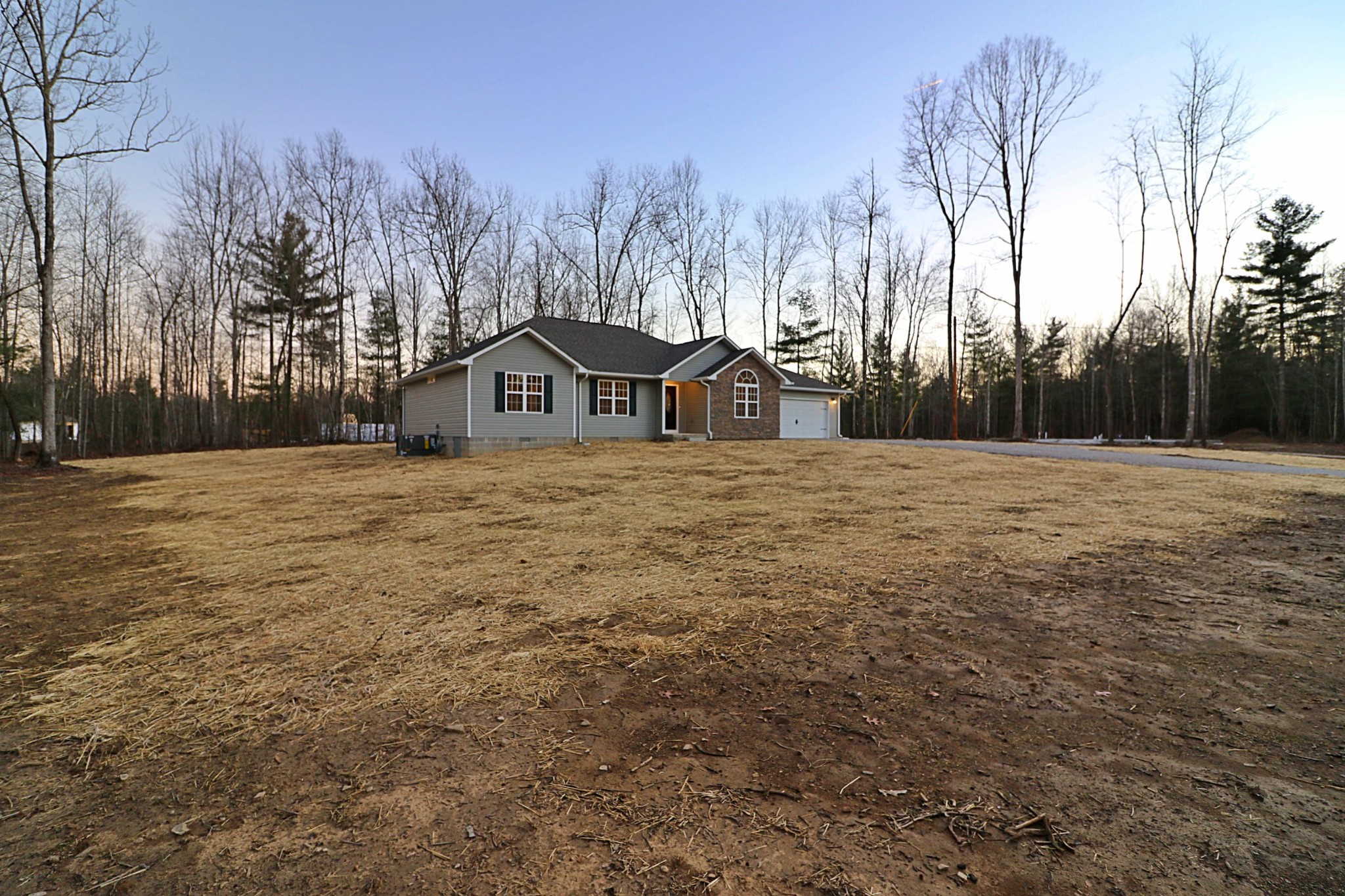 971 Toomey Falls Road Oneida, TN 37841 - Photo 7 of 16 a big white house with a big yard and large trees