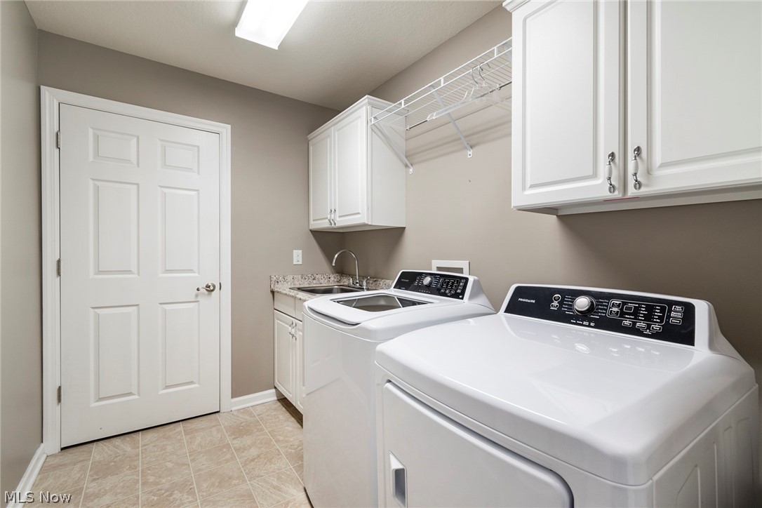 9151 Springfield Road, Unit 1902 Youngstown, OH 44514 - Photo 29 of 36 Laundry area with independent washer and dryer, sink, light tile flooring, and cabinets