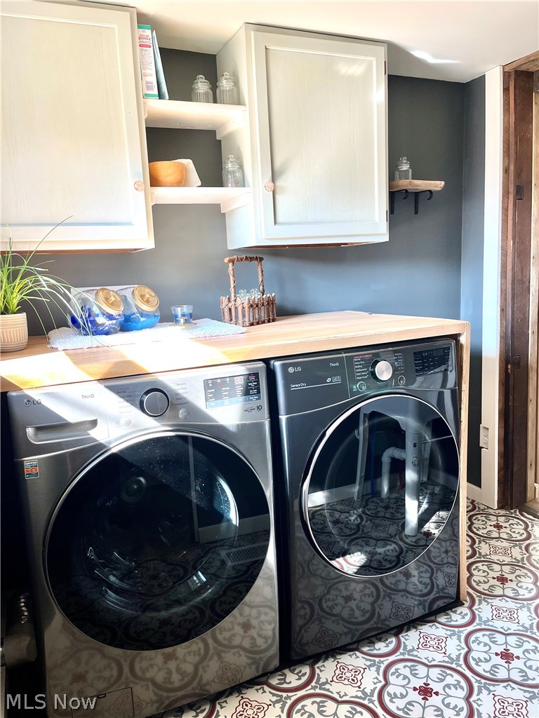 12972 Gilmore Road Southeast Port Washington, OH 43837 - Photo 17 of 50 Laundry room featuring washing machine and clothes dryer and cabinet space