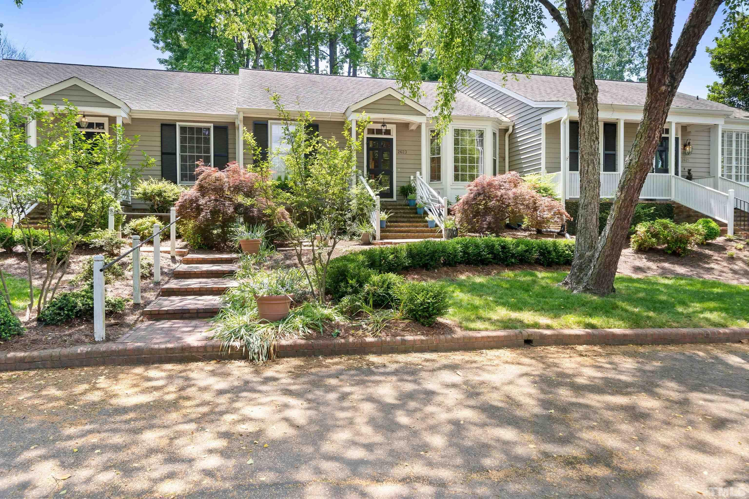 2623 Ashland Street Raleigh, NC 27608 - Photo 1 of 18 a front view of a house with a garden
