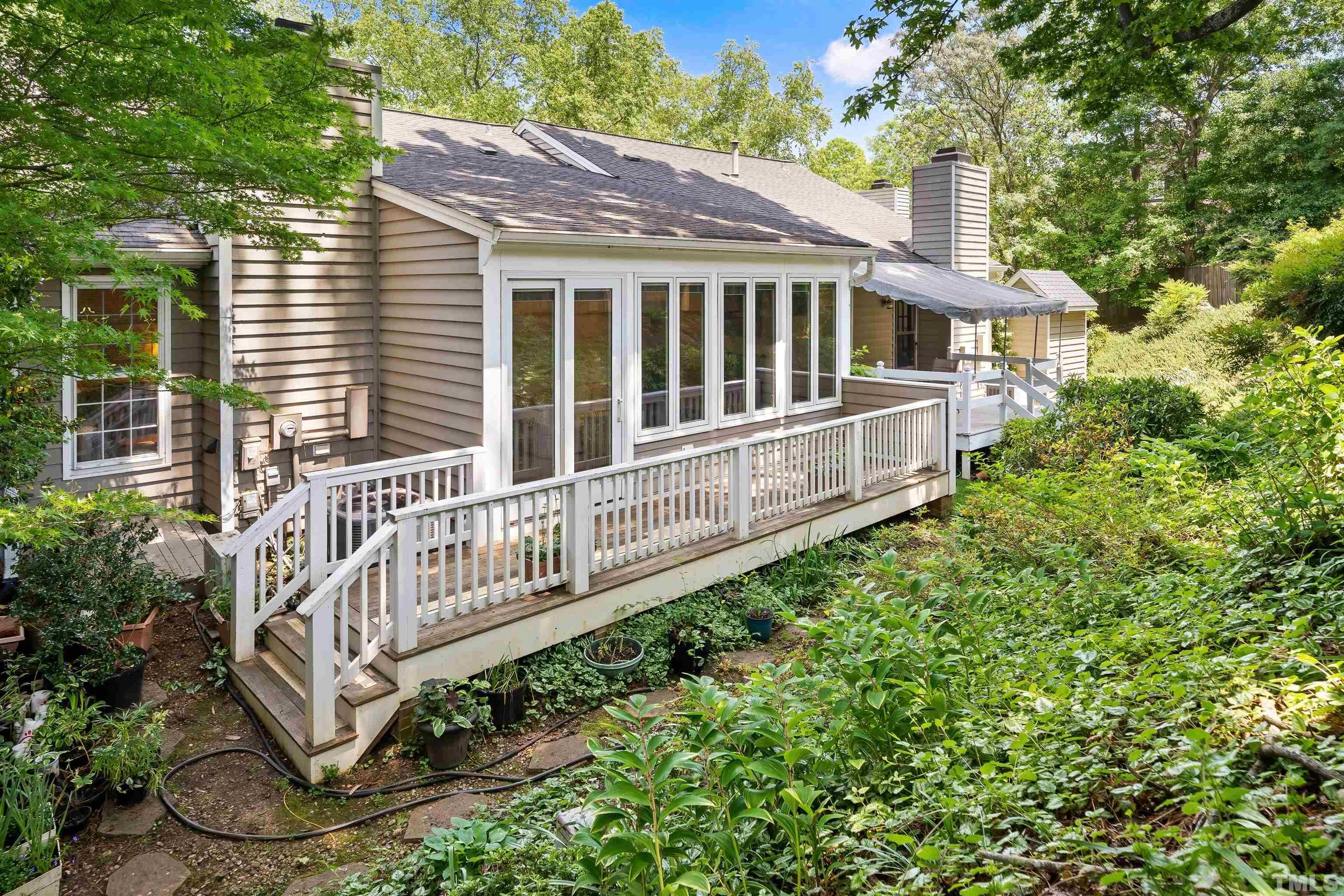 2623 Ashland Street Raleigh, NC 27608 - Photo 18 of 18 a view of a house with a deck and a yard
