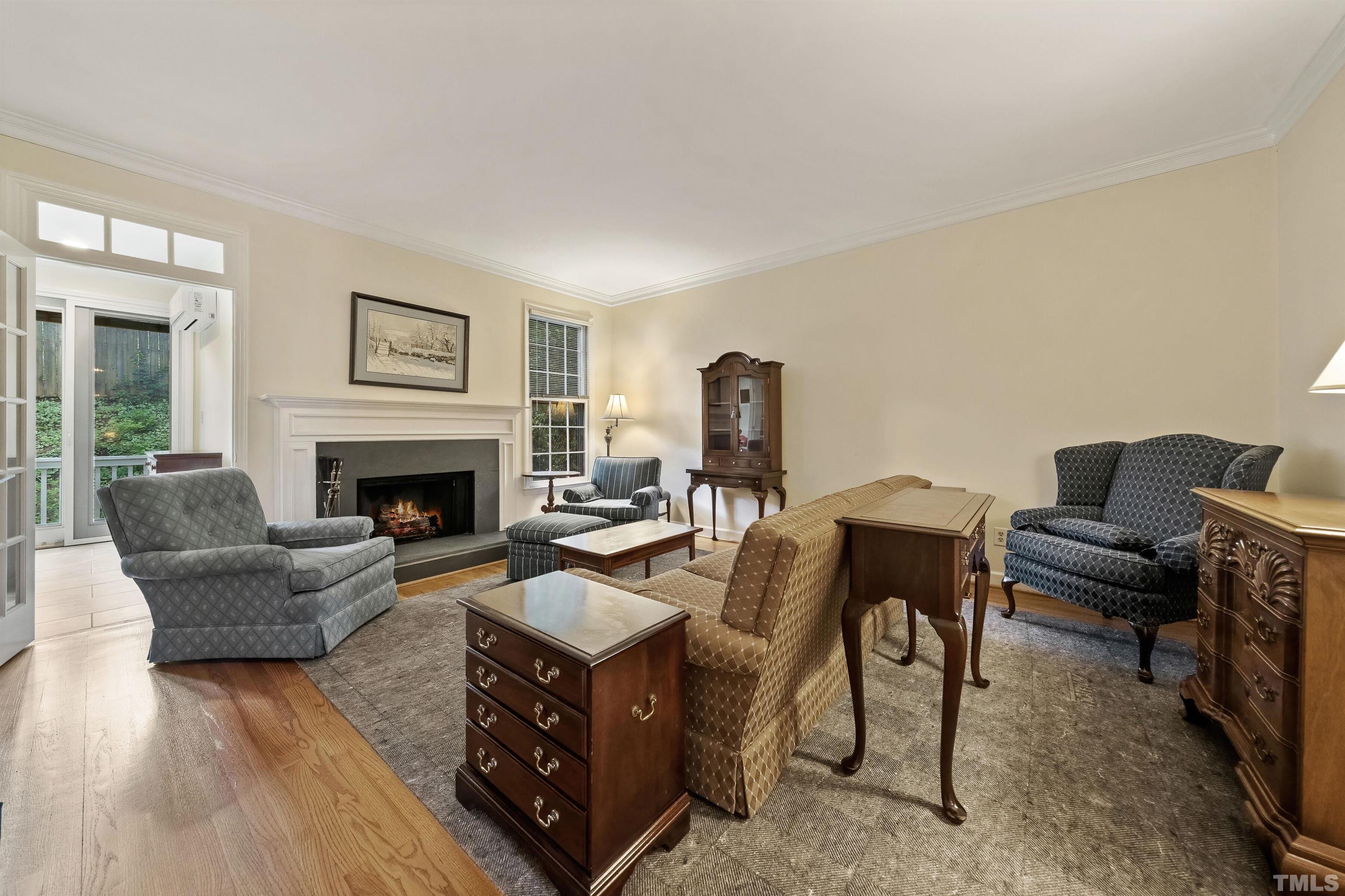 2623 Ashland Street Raleigh, NC 27608 - Photo 8 of 18 a living room with furniture and a fireplace