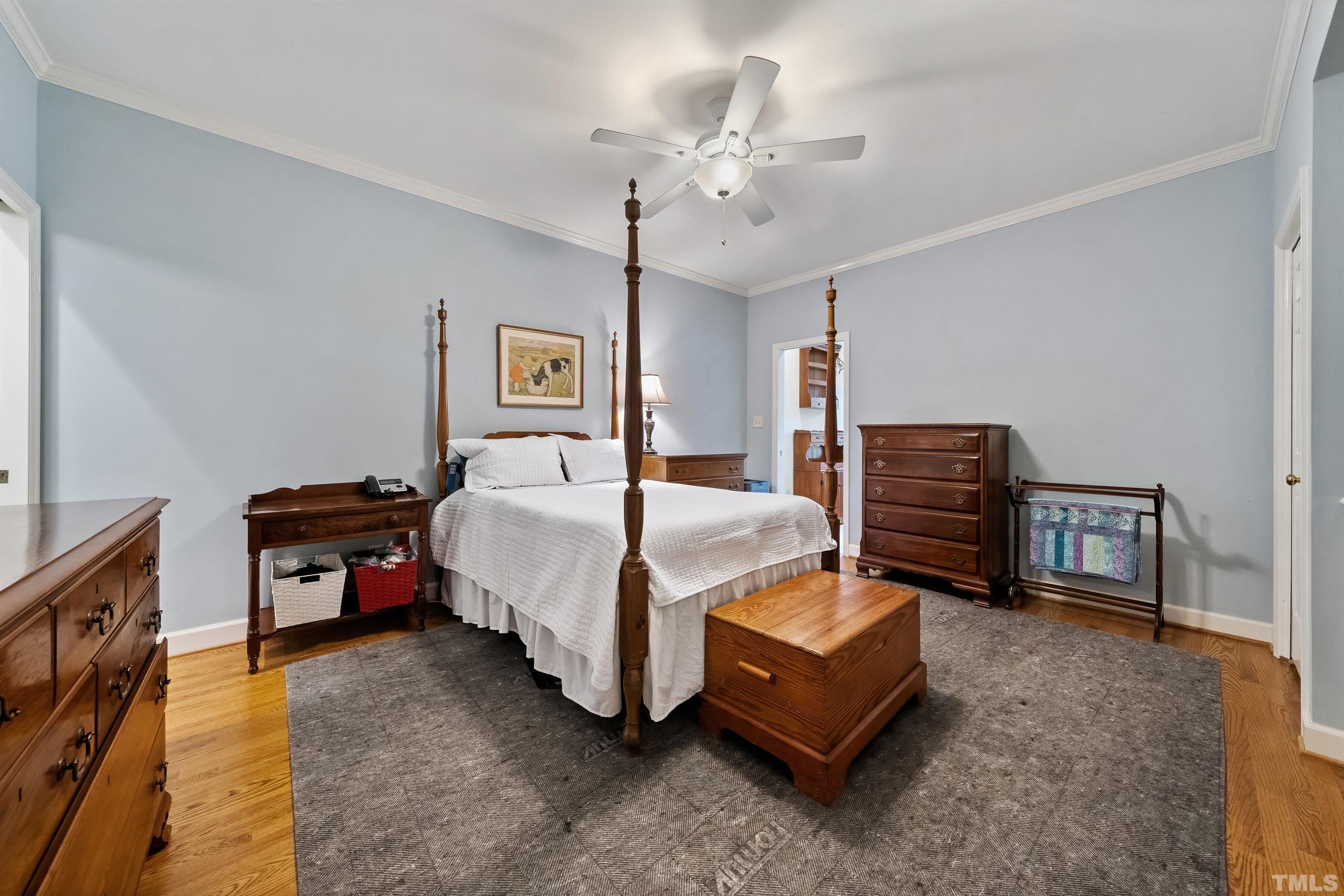 2623 Ashland Street Raleigh, NC 27608 - Photo 9 of 18 a bedroom with bed and a chandelier