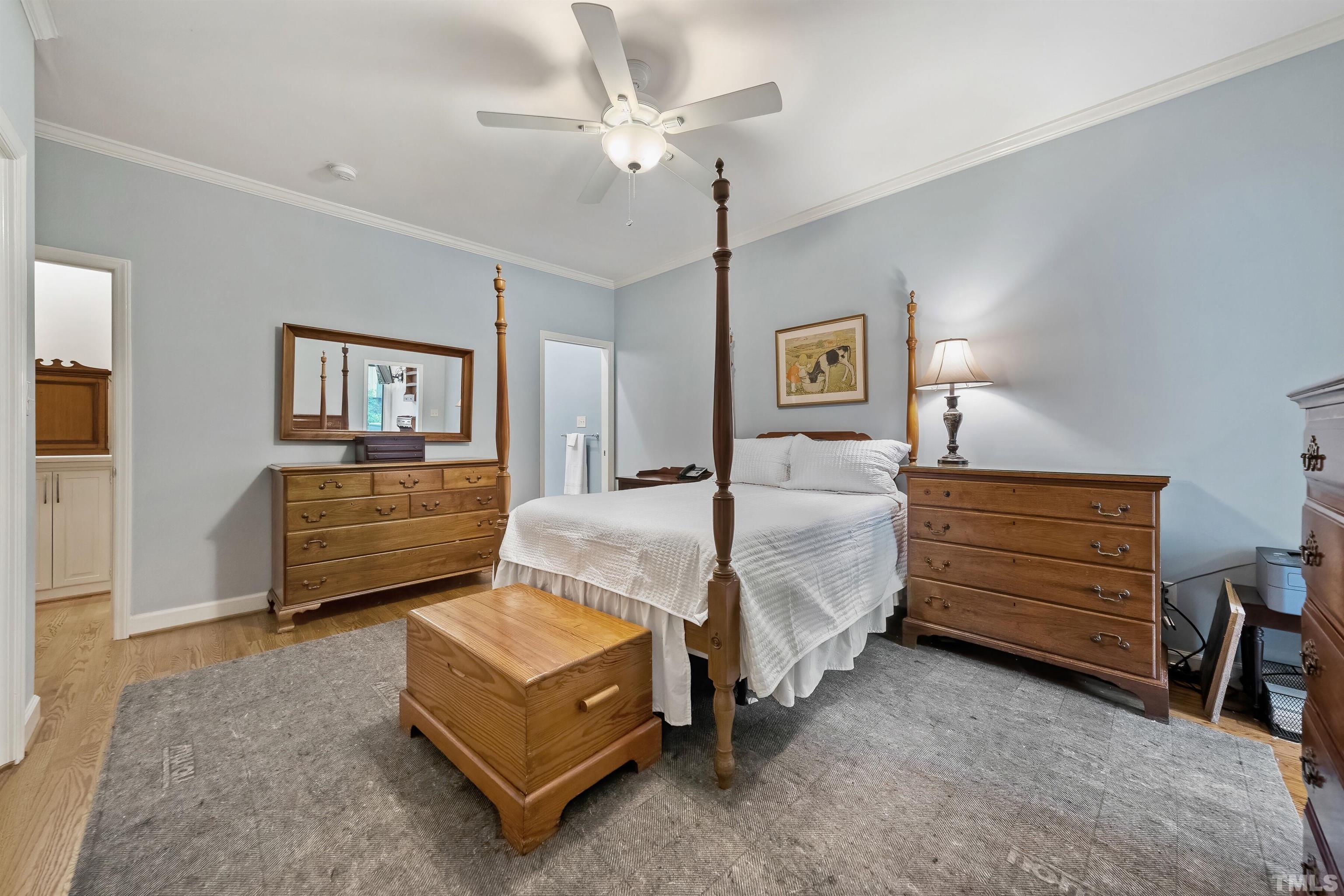 2623 Ashland Street Raleigh, NC 27608 - Photo 10 of 18 a bedroom with a bed and ceiling fan