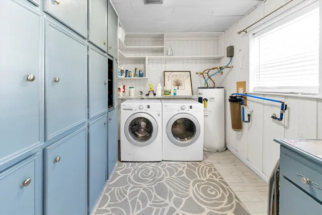 a view of kitchen with stainless steel appliances wooden floor and window
