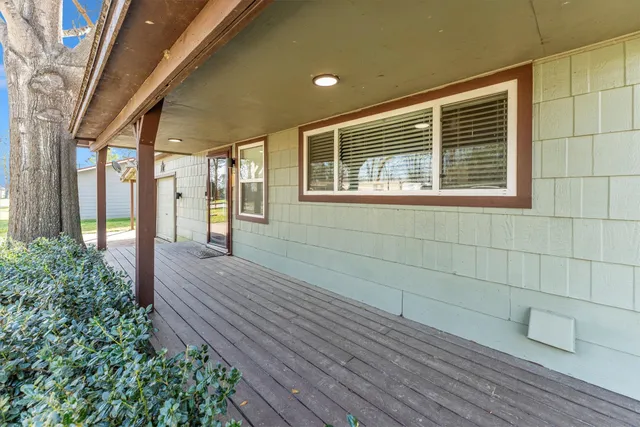 a view of a house with a backyard and a tree