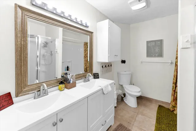 a spacious bedroom with a bed and a chandelier