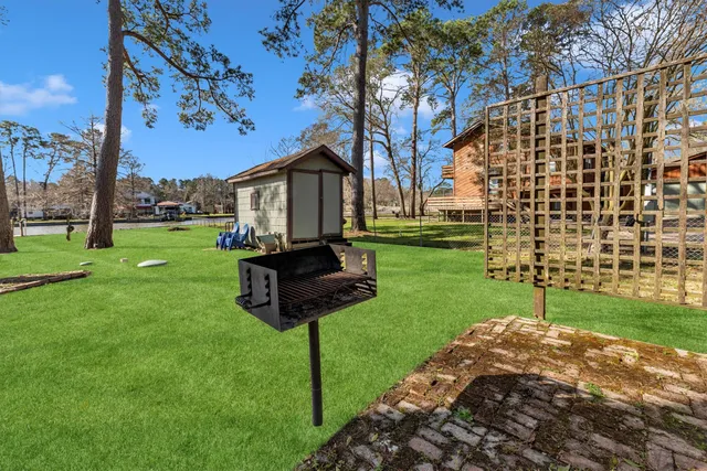 a view of a park with a bench and trees