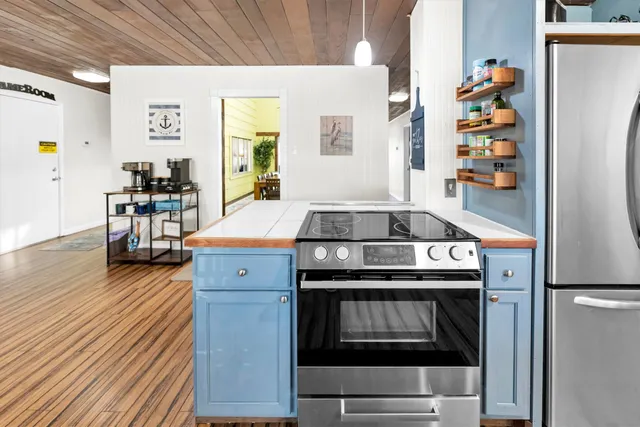 a view of a room with wooden floor and windows