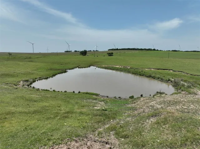 an aerial view of a residential houses with a yard