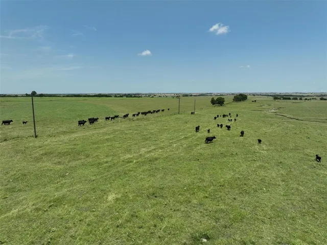 an aerial view of a residential houses with outdoor space