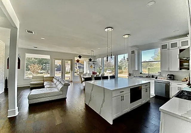 a kitchen with sink stove and cabinets