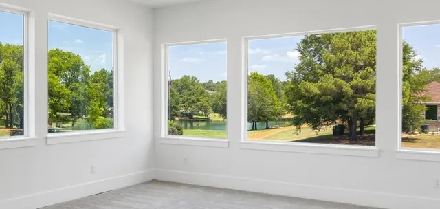 a view of a room that has a large window and front of house