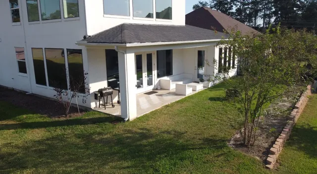 a front view of a house with a yard table and chairs