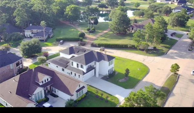an aerial view of a house with yard swimming pool and outdoor seating