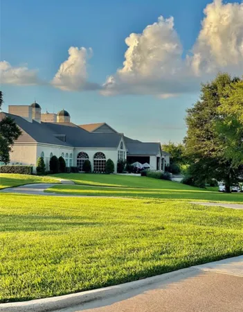 a front view of a house with a big yard