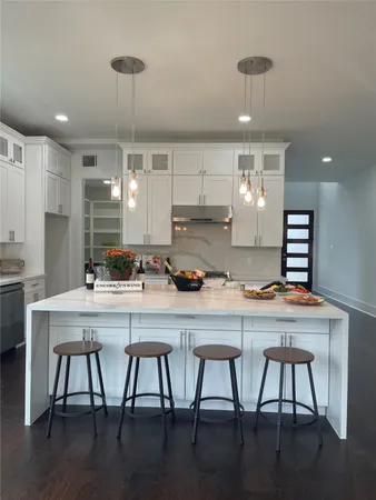 a kitchen with a table chairs stove and cabinets