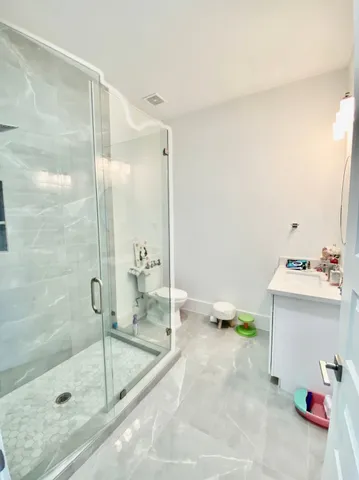 a bathroom with a sink toilet and shower