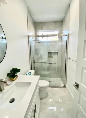 a bathroom with a sink toilet and shower