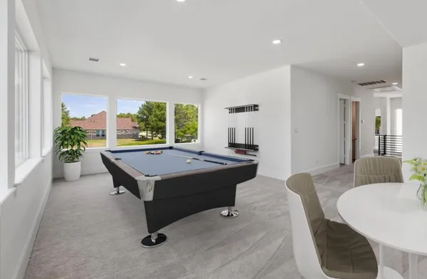a living room with a table chairs and a table