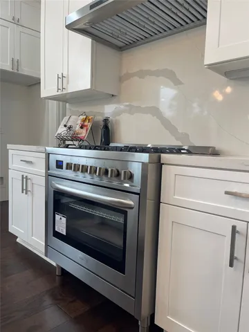 a stove top oven sitting inside of a kitchen