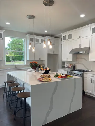 a kitchen with a table chairs stove and cabinets